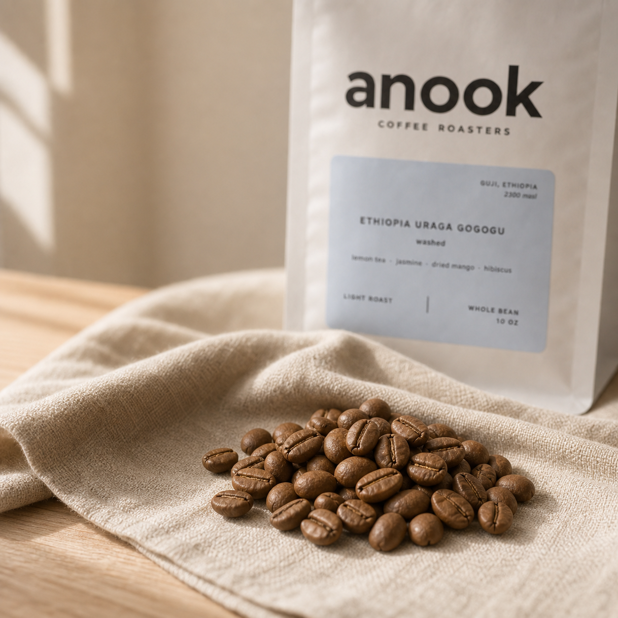 Light roasted coffee beans with Anook coffee bag in the background