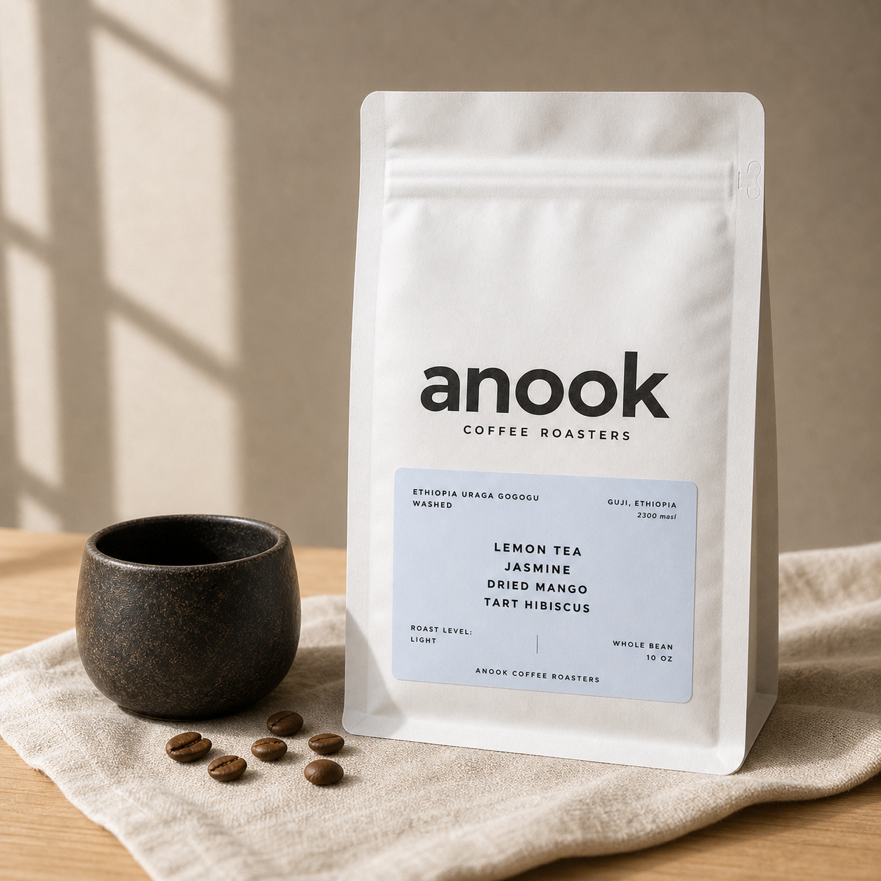 Anook Ethiopia Uraga Gogogu coffee bag beside a ceramic cup